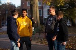 group of 4 students talking